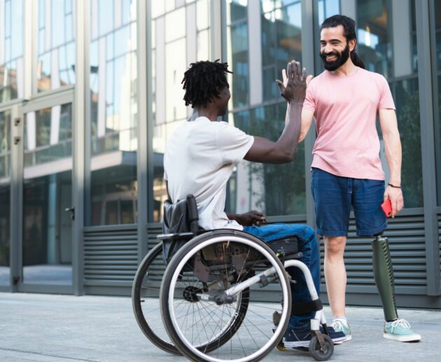 A pair of disabled friends on vacation having fun and breaking down barriers.