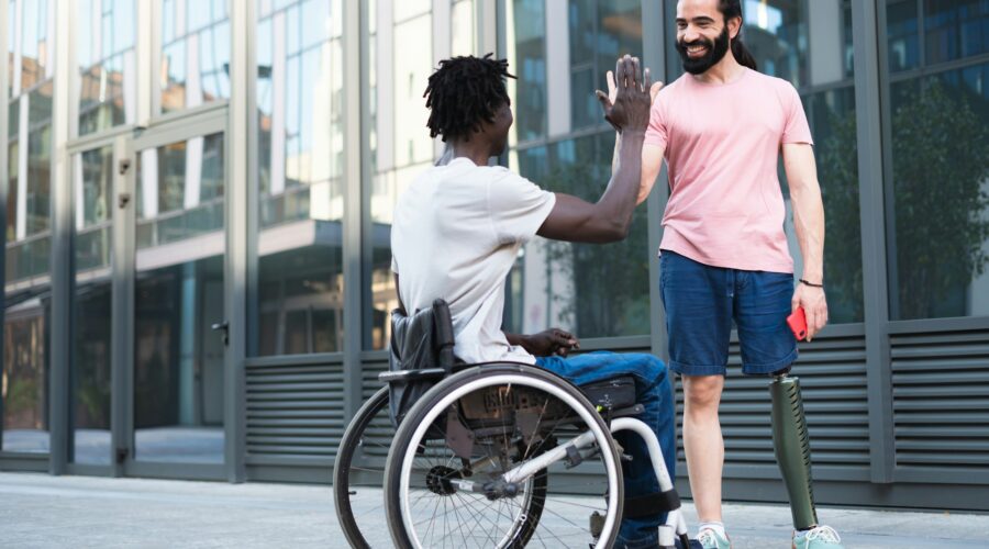 A pair of disabled friends on vacation having fun and breaking down barriers.