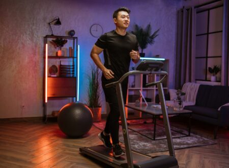 Attractive young sports asian man doing fitness exercise, running on treadmill .