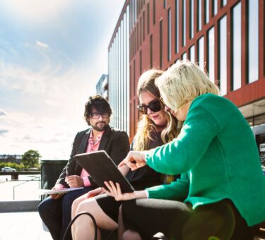 Business people discussing over digital tablet at Malmo Live