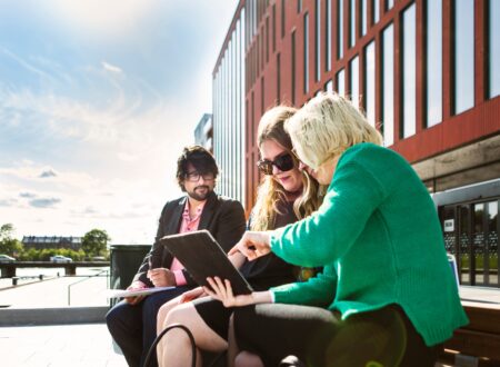 Business people discussing over digital tablet at Malmo Live