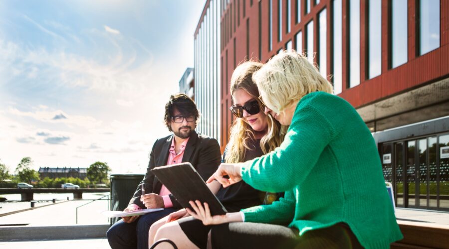 Business people discussing over digital tablet at Malmo Live