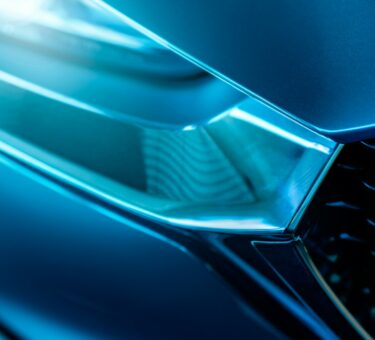 Closeup detail of blue luxury car. Electric vehicle with modern technology. Expensive car. Shiny