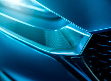 Closeup detail of blue luxury car. Electric vehicle with modern technology. Expensive car. Shiny