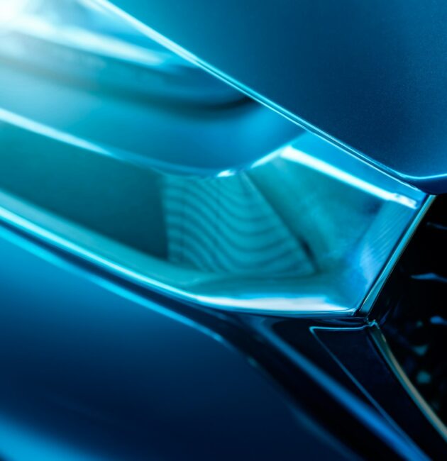 Closeup detail of blue luxury car. Electric vehicle with modern technology. Expensive car. Shiny