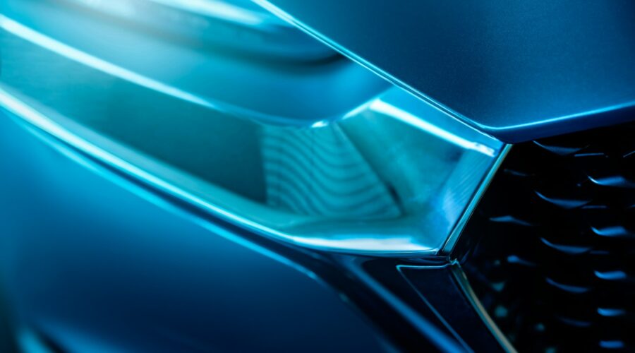 Closeup detail of blue luxury car. Electric vehicle with modern technology. Expensive car. Shiny