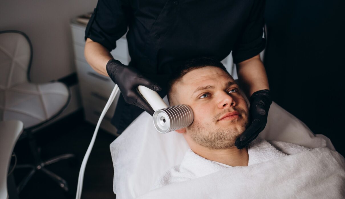 Face cryomassage, caucasian man. Skin cryotherapy close up. Liquid nitrogen use in medicine