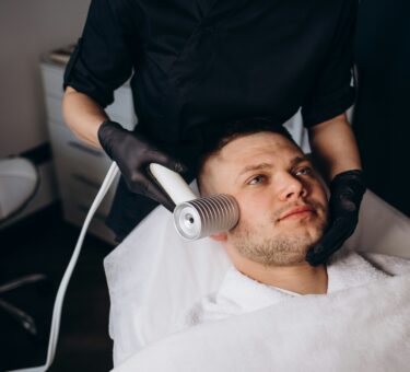 Face cryomassage, caucasian man. Skin cryotherapy close up. Liquid nitrogen use in medicine