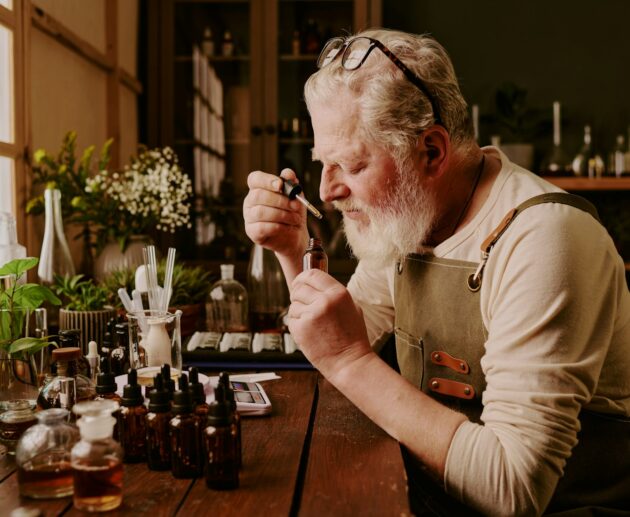 Mature Perfumer Smelling Perfume Scent