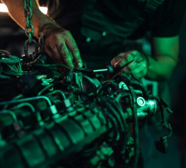 Mechanic working on the detailed parts of a vehicle engine