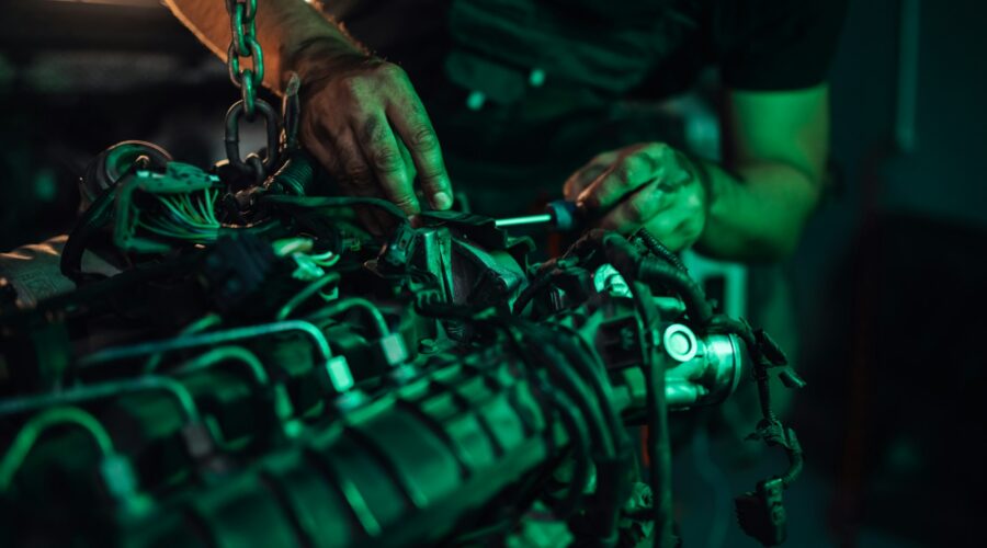 Mechanic working on the detailed parts of a vehicle engine