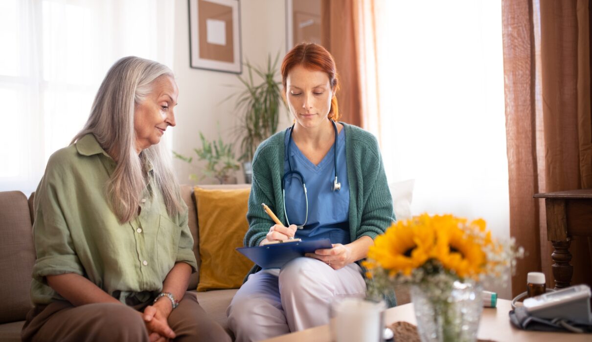 Nurse cosulting with senior her health condition.