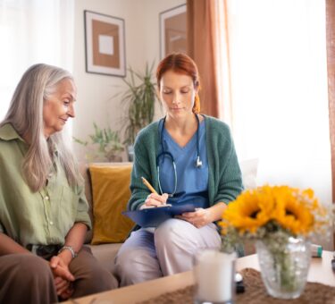 Nurse cosulting with senior her health condition.