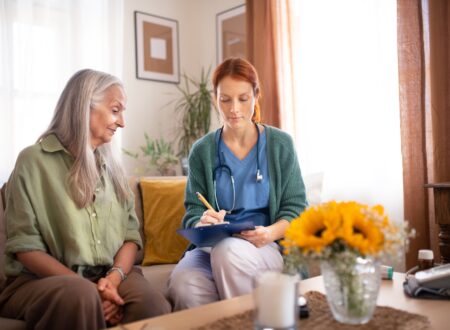 Nurse cosulting with senior her health condition.