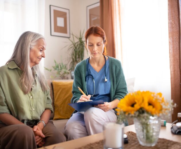 Nurse cosulting with senior her health condition.