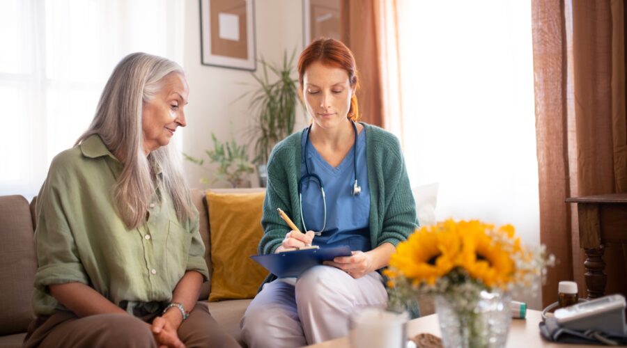 Nurse cosulting with senior her health condition.