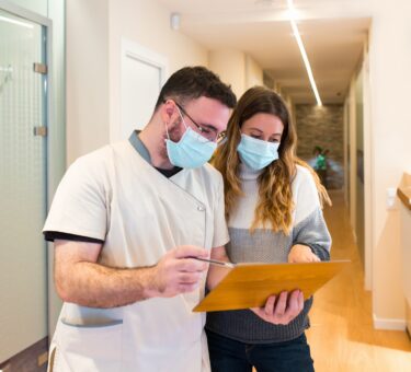 Nurse explaining notes to female patient in health center