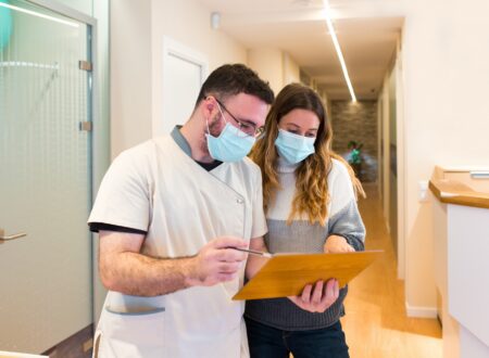 Nurse explaining notes to female patient in health center