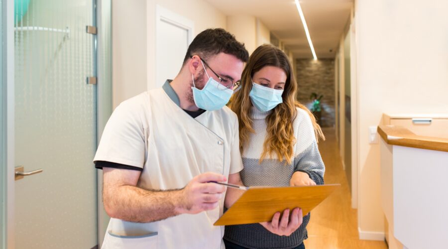 Nurse explaining notes to female patient in health center