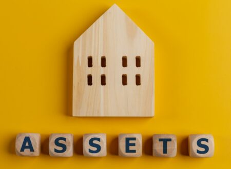 The word assets written on wooden cubes with assets icon on yellow background. Asset management