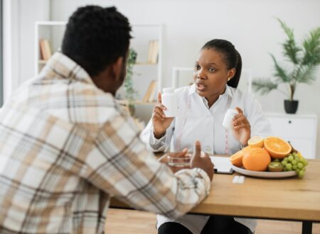 Woman with food supplements chatting with man in hospital