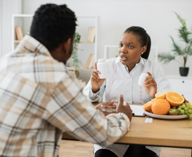 Woman with food supplements chatting with man in hospital