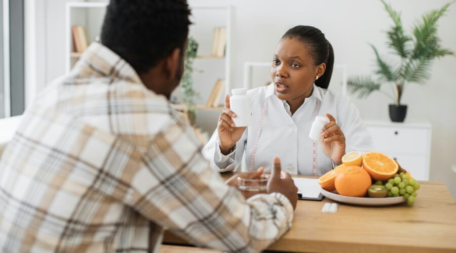 Woman with food supplements chatting with man in hospital