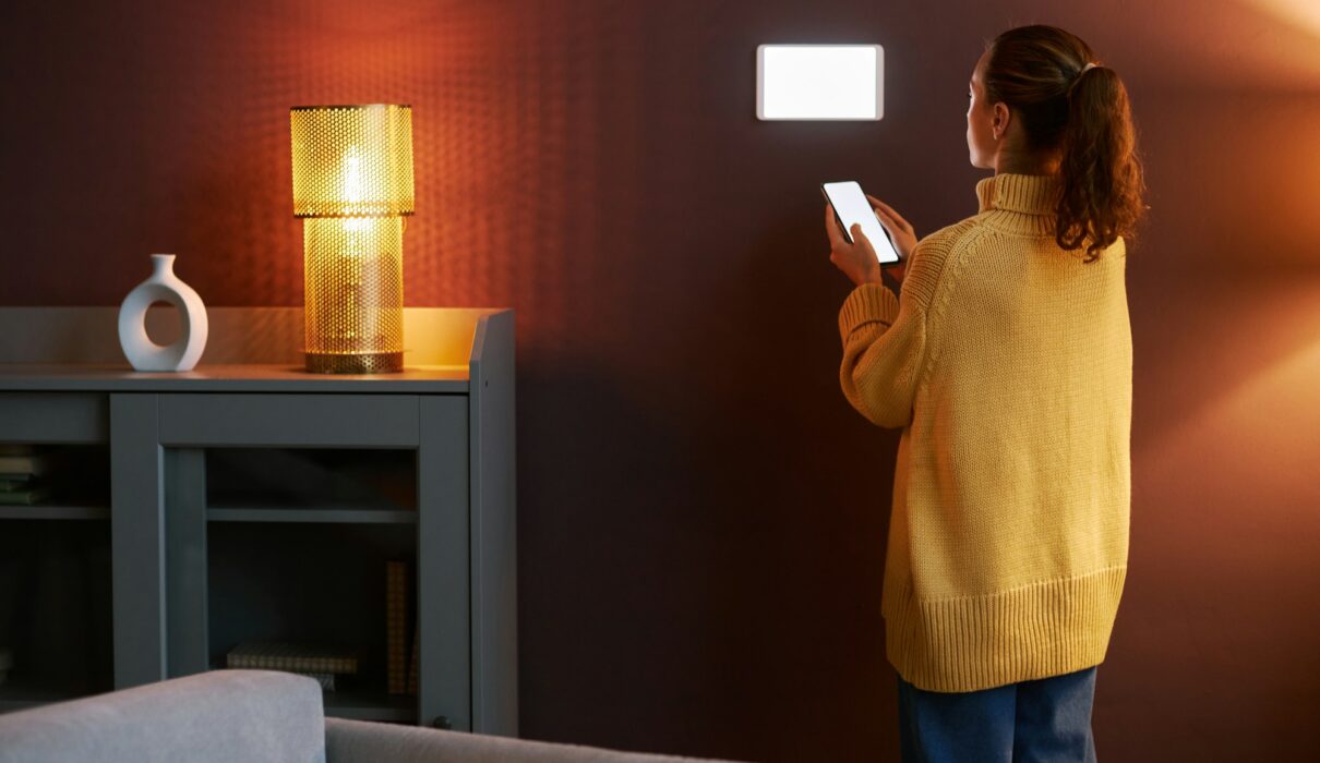 Young woman using digital smart home system