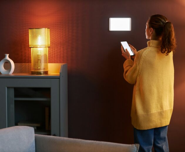 Young woman using digital smart home system