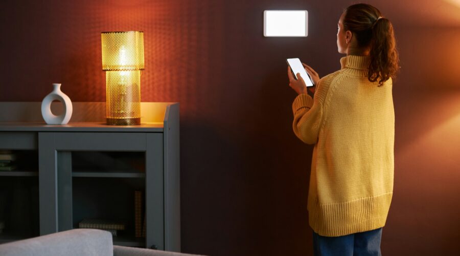 Young woman using digital smart home system